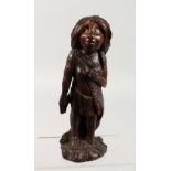 AN UNUSUAL CARVED HARDWOOD TRIBAL FEMALE FIGURE. 10ins high.