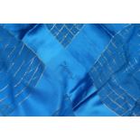 AN YVES SAINT LAURENT BLUE SILK AND THREAD SCARF.