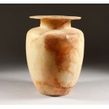 AN EGYPTIAN ALABASTER CANOPIC STYLE JAR. 11ins high.