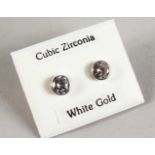 A PAIR OF 9CT GOLD CZ STUD EARRINGS.