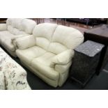A cream leather two seater settee.
