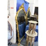 A large decorative gilt framed mirror 6ft 2ins high x 4ft 4ins wide.