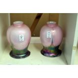 A pair of colourful glass lamp shades.