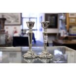 A small pair of silver candlesticks.