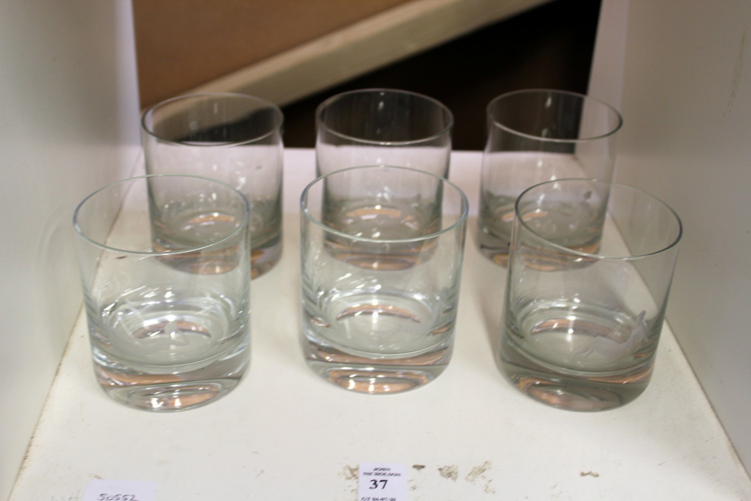 A set of six glass whisky tumblers etched with reclining female nudes.