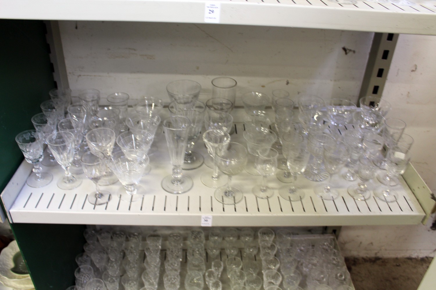 A shelf of cut glass drinking glasses.