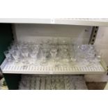 A shelf of cut glass drinking glasses.