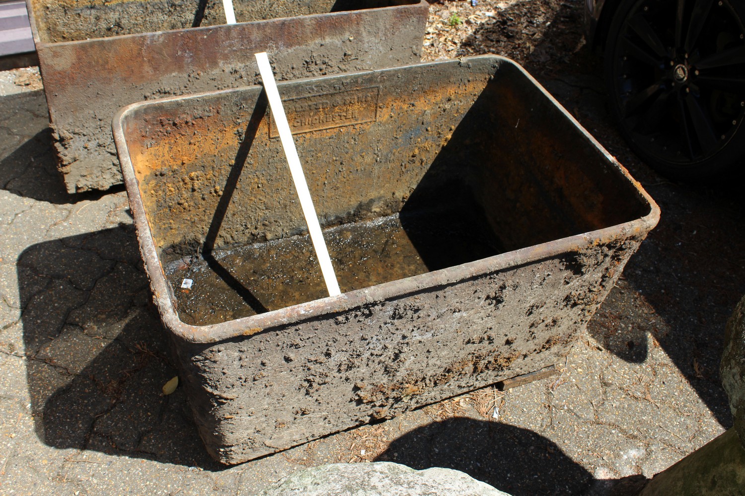 Halsted & Sons, Chichester, a large cast iron water trough 3ft 1ins wide.