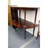 A George III mahogany dining table comprising a pair of D-shaped ends with gate-leg action and two