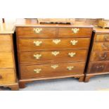 A George III mahogany chest of two short and three graduated long drawers on bracket feet.