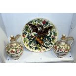 A large continental pottery charger decorated with a dragon together with a pair of continental