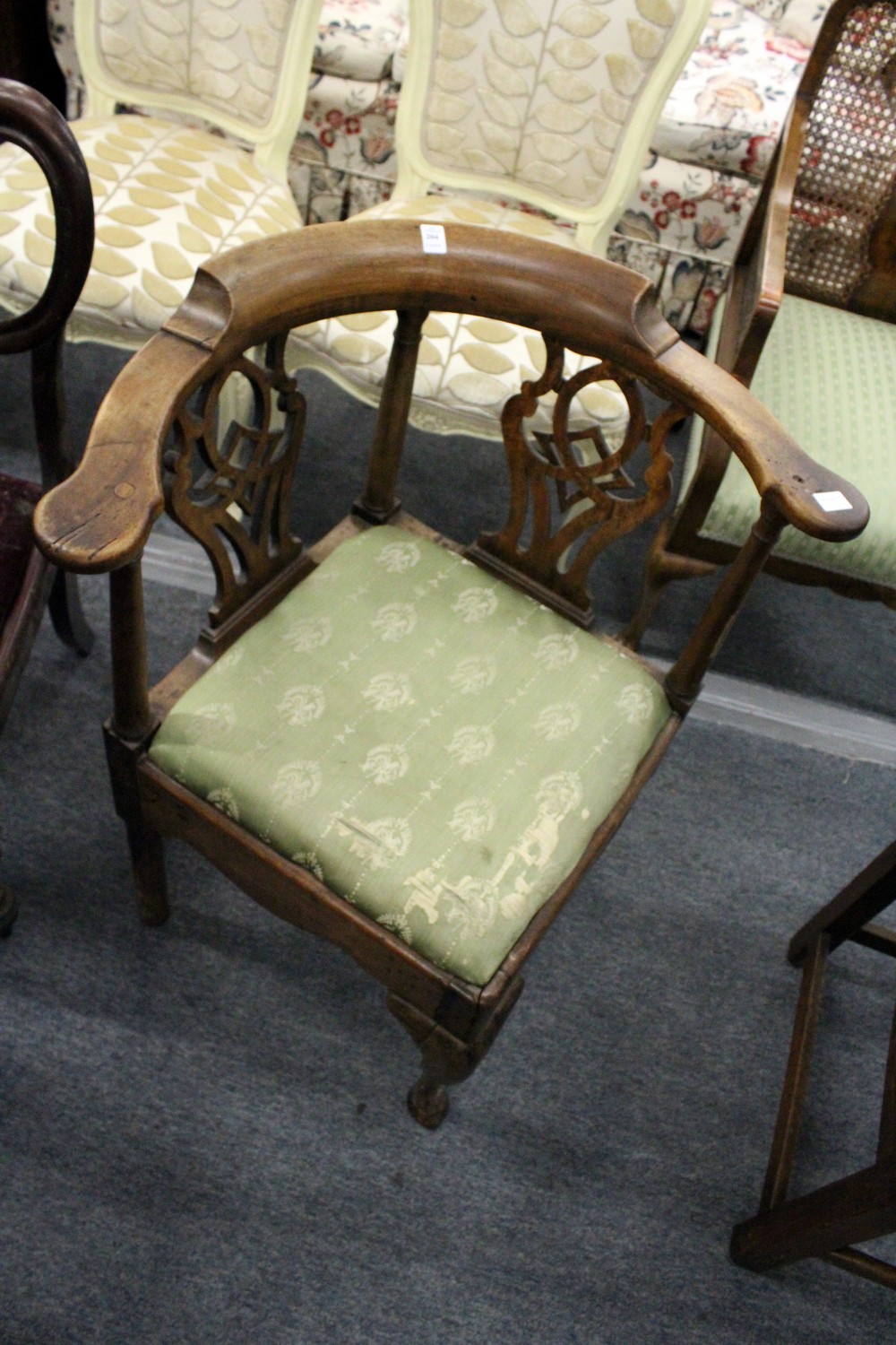 A George III mahogany corner armchair.