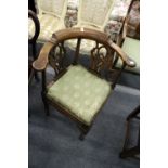 A George III mahogany corner armchair.