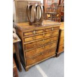 A George III mahogany and cross-banded chest of two short and four graduated long drawers on bracket