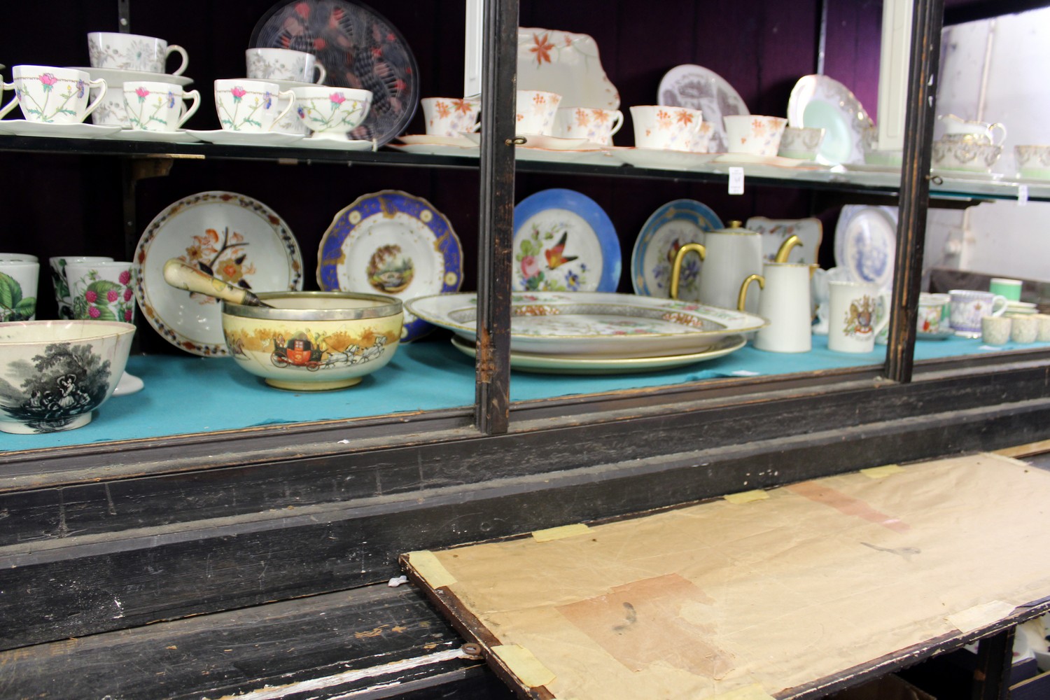 A large shelf of decorative china.