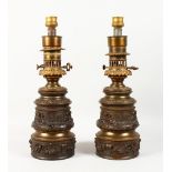 A good pair of 19th century French bronzed lamps with classical cupid decoration. 15ins high.