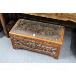 A Chinese carved camphor wood coffer.