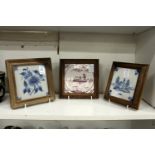 Three Delft tiles, framed and glazed.