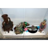 An African pottery vessel, an eastern headdress and other decorative items.