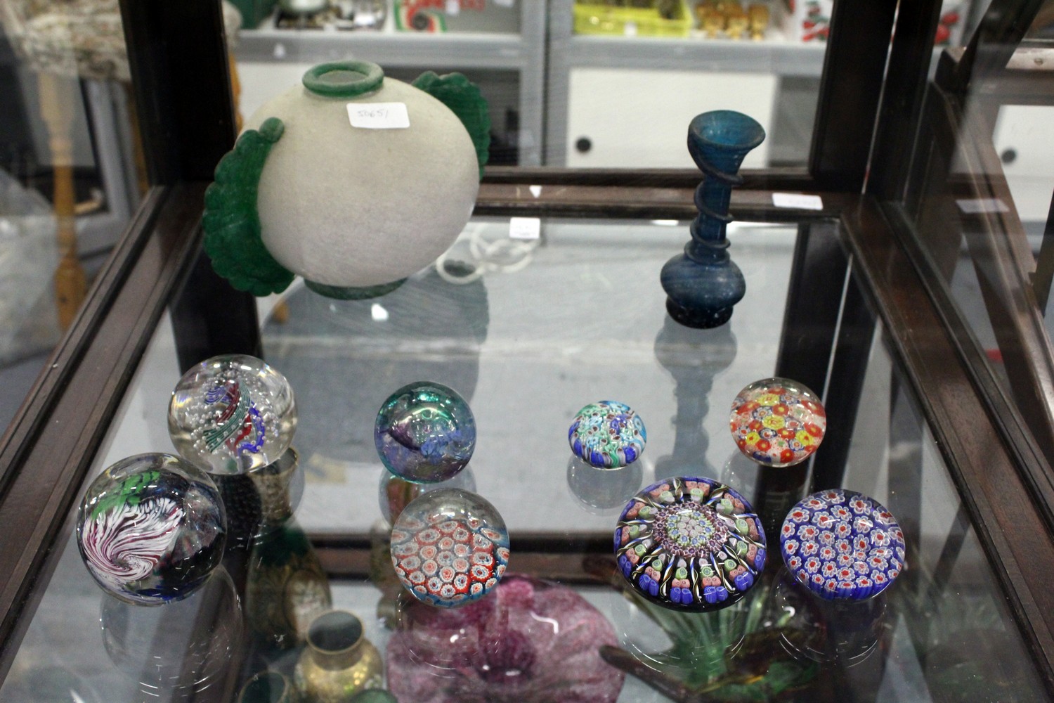 A small collection of glass paperweights and other items.