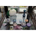 A small collection of glass paperweights and other items.