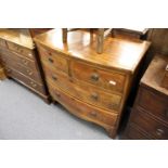 A George III mahogany small bow front chest of two short and two long drawers on bracket feet.