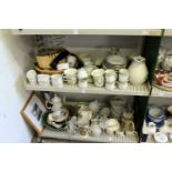 Two shelves of decorative and household glass and china.