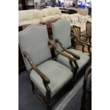 A pair of beech framed upholstered open armchairs.