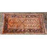 A small 20th century Persian design rug, rust ground with two tree design motifs. 3ft 7ins x 2ft