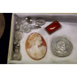 A carved cameo collector's coin and other items.