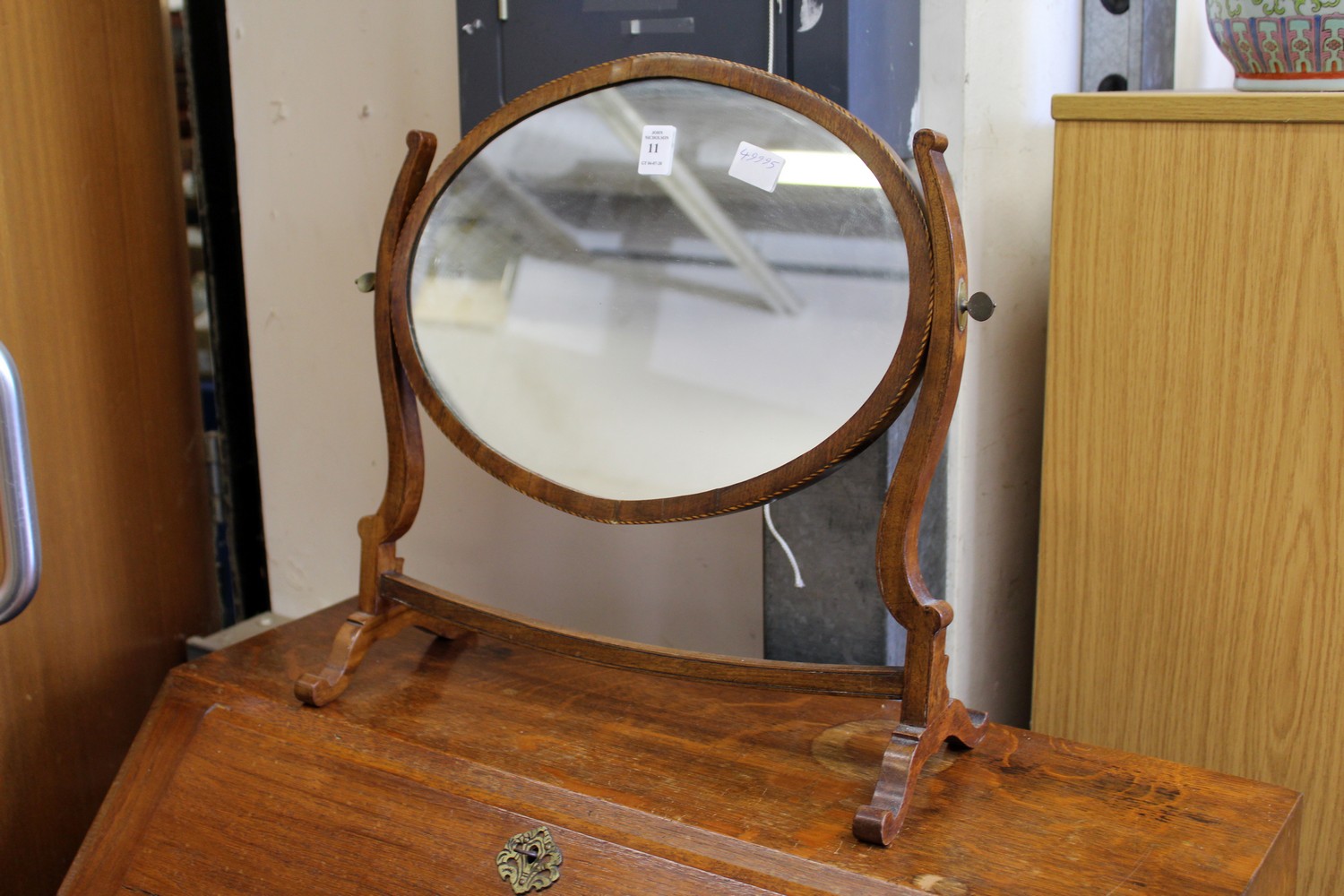 A mahogany oval dressing table mirror.