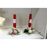 A pair of porcelain candlesticks modelled as fruit and leaves.