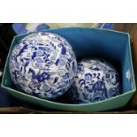 Two blue decorated pottery spheres.
