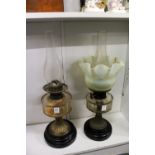Two Victorian oil lamps, one with a Vaseline glass shade.