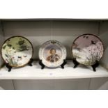 A pair of Japanese plates decorated with ducks on a pond together with a continental portrait