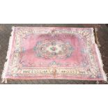 A 20th century Chinese carpet, pink ground with floral decoration. 9ft 0ins x 6ft 0ins.