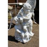 A white painted composite garden ornament modelled as two cherubs.