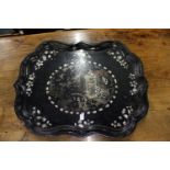 A large Victorian papier mache tray with inlaid decoration.