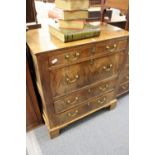 A George III oak and mahogany four drawer chest.