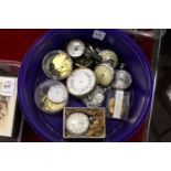 A collection of pocket watches and barometers (in various states of repair).