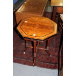 An Edwardian figured walnut and ebonised octagonal shaped centre table on turned and fluted supports