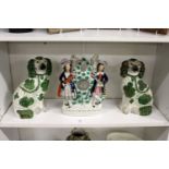 A pair of Staffordshire spaniels with green and gilt decoration together with a Staffordshire flat