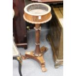 A 19th century rosewood circular jardiniere stand with carved column on a concave sided base with