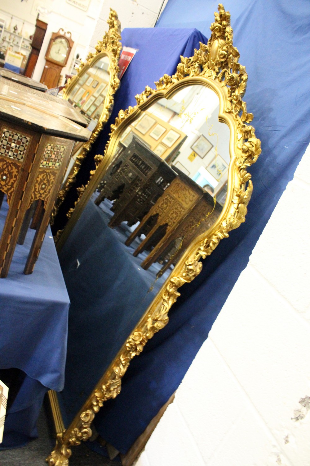 A large decorative gilt framed mirror 6ft 2ins high x 4ft 4ins wide.