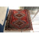 A Persian Shiraz rug 7ft x 5ft.