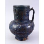 A FINE EARLY ISLAMIC BLUE GLAZED POTTERY JUG, with a moulded body, 22cm high.