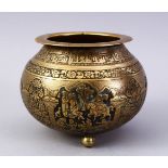 A GOOD ISLAMIC BRASS TRIPLE FOOT CALLIGRAPHIC BOWL, with panels of figures and bands of calligraphy,