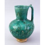 A GOOD EARLY ISLAMIC TURQUOISE GLAZED POTTERY JUG, 22cm high.