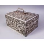 A FINE 19TH CENTURY INDIAN CUTCH SILVER CASKET, the hinged lid and body profusely embossed and