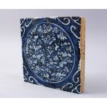 A GOOD CHINESE MING STYLE BLUE & WHITE TILE, decorated with flora, 20cm square.